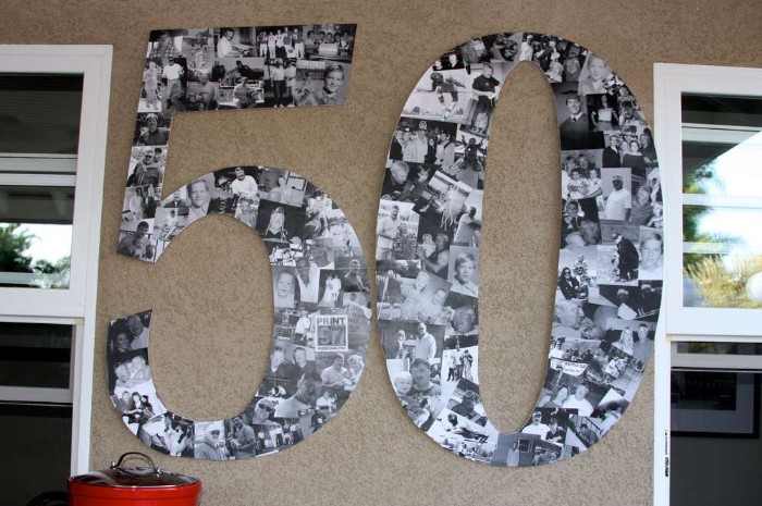 photographs in black and white, making up a large wall decoration, shaped like the number 50, on a beige wall, between two windows, birthday decoration ideas
