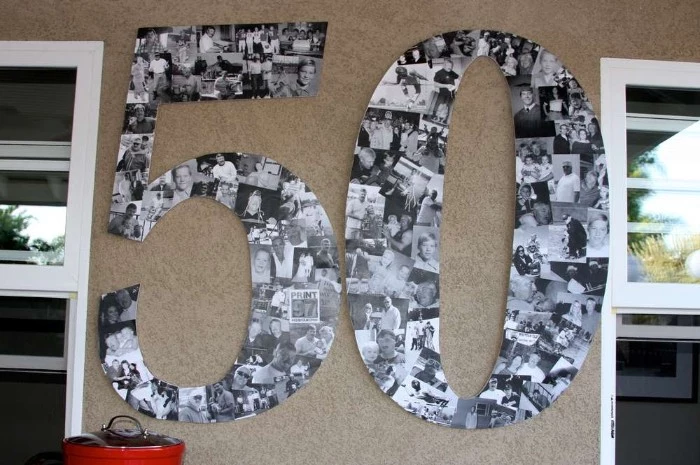 photographs in black and white, making up a large wall decoration, shaped like the number 50, on a beige wall, between two windows, birthday decoration ideas