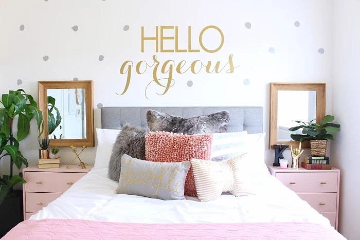 hello gorgeous written in gold, on a white wall, decorated with silver dots, teen bedrooms, symmetrical set up, with a bed covered in cushions, and surrounded by two mirrors