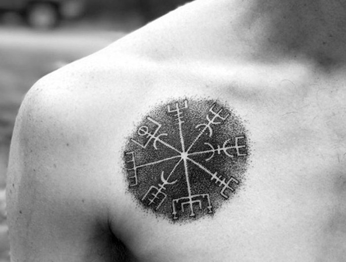 icelandic symbol with a round shape, known as vegvisir, small meaningful tattoos, on the right hand side, above the chest, of a man seen in close up