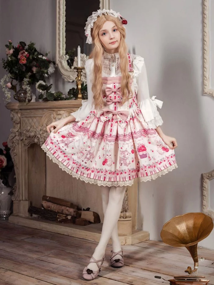 several bows and a pink pattern, decorating a white frilly sweet lolita dress, worn by a slim girl, in a long strawberry blonde wig