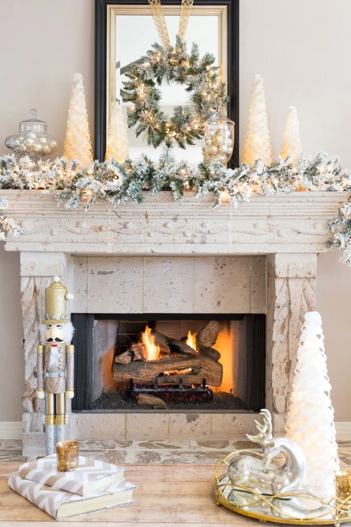nutcracker ornament and several candles, shaped like christmas trees, on and near, a vintage style stone fireplace, in light cream, fireplace decor, green wreath with glowing fairy lights