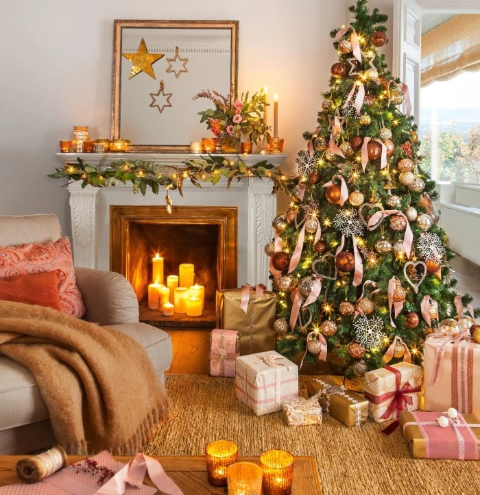 several glowing candles, placed inside a fireplace, decorated with a green garland, and fairy lights, holiday images, lavish christmas tree and presents nearby