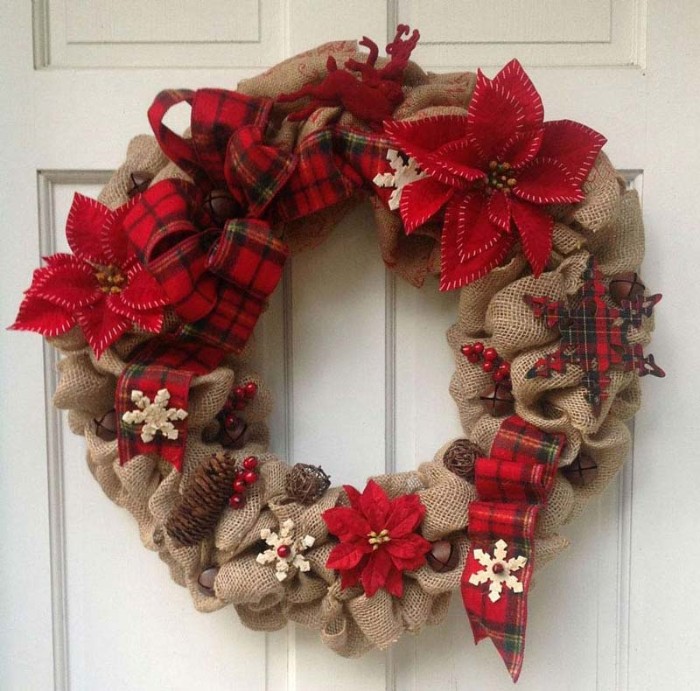 burlap festive wreath, decorated with fir cones, tiny red faux berries, snowflake ornaments and poinsettia flowers, made from red felt, wreath ideas, red tartan ribbon, tied in a bow