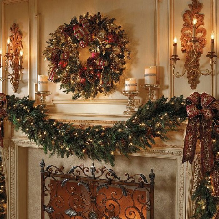 classic christmas decorations, a pine garland, covered in small, glowing fairy lights, and a wreath with pine cones, red baubles and fairy lights, near a fireplace, with a beautiful wrought iron grate