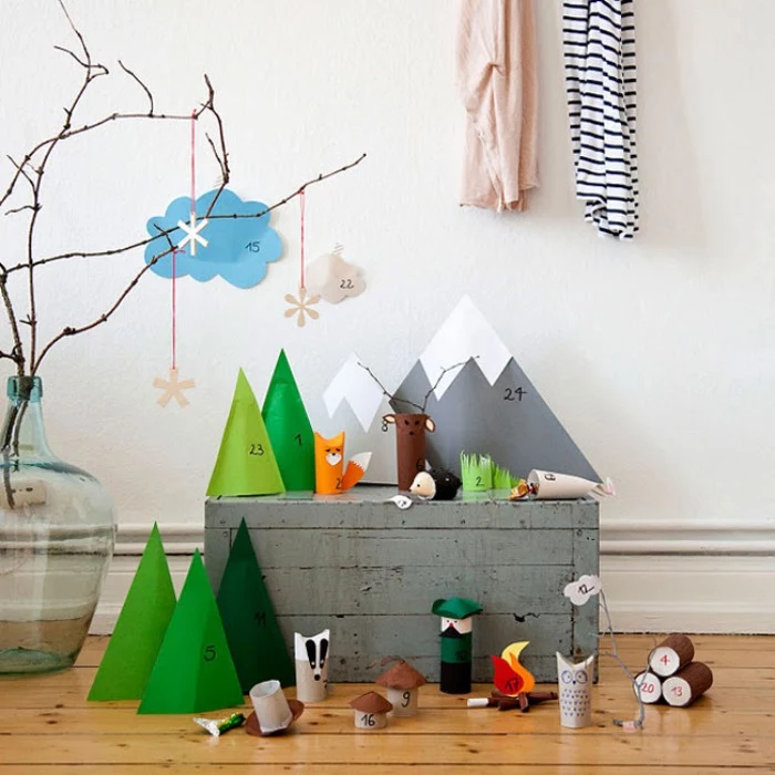 mountains and trees, and woodland animals, made from colorful paper, each paper shape has a small number, from 1 to 24