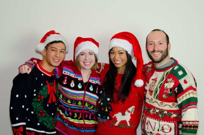 group of four smiling friends, wearing tacky, multicolored jumpers with various festive patterns, ugly christmas sweater ideas, snowmen and a christmas wreath, rocking horse and santas