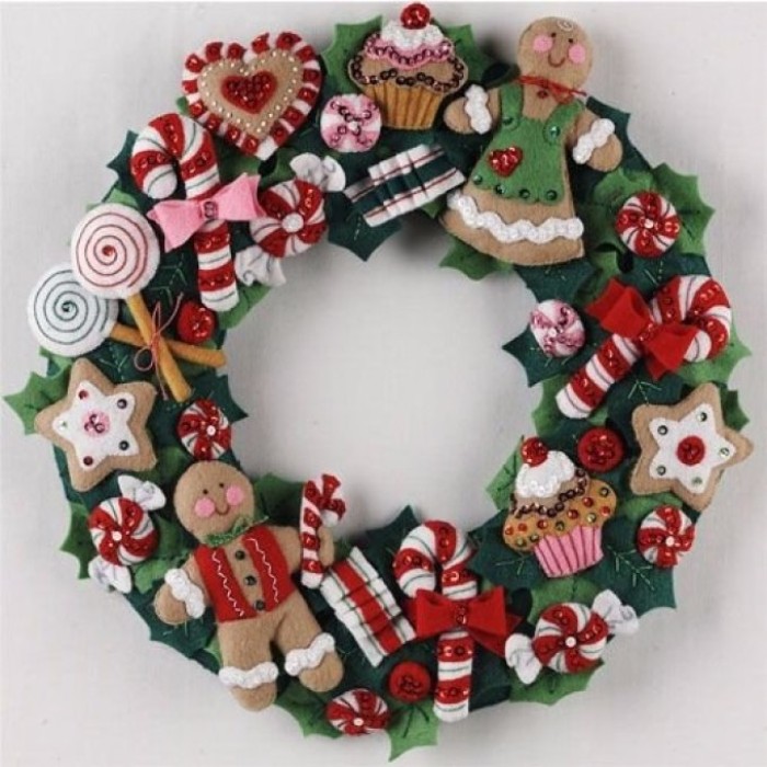 felt wreath featuring various shapes, of candy and sweets, gingerbread man and woman, lollypops and cupcakes, cookies and candy canes