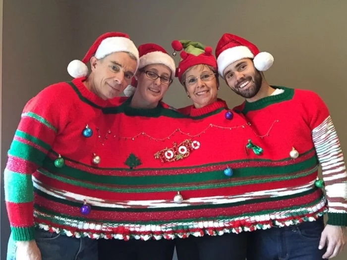 shared family jumper, in red and green, decorated with baubles and ornaments, worn by a family of four, with santa hats, cute ugly christmas sweater