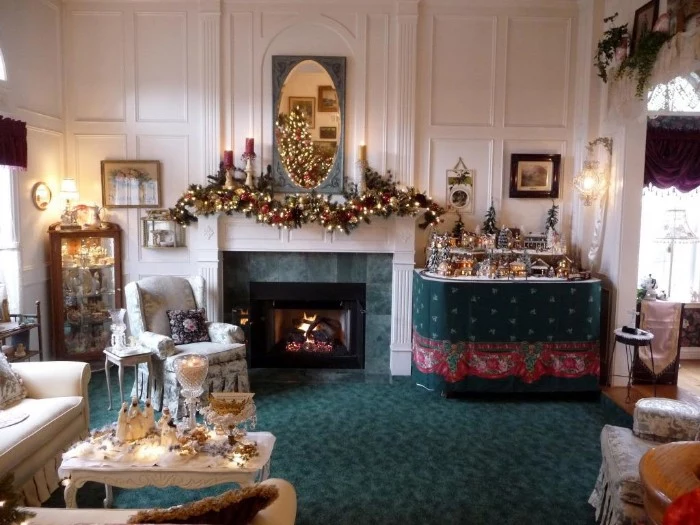 spacious living room, with fireplace mantel decor, featuring a garland, covered in glowing fairy lights