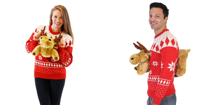 plush reindeer toys, stuck to the front, and the back, of two white and red jumpers, worn by a brunette woman, and a dark-haired man