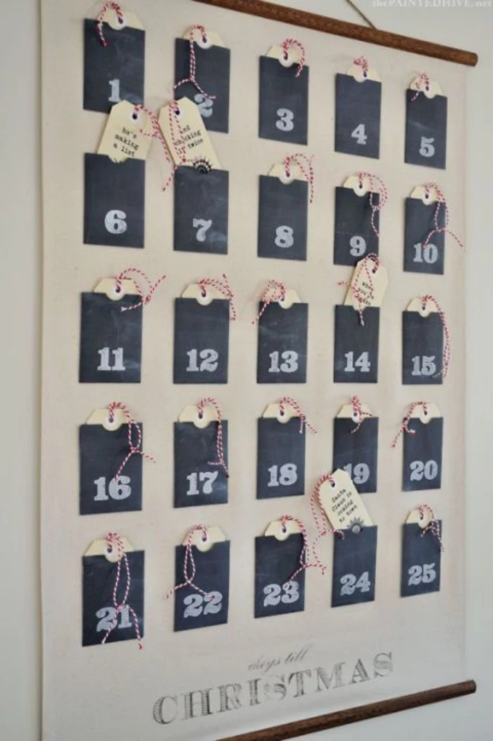 25 black pockets, attached to a white poster, each posket has a number, written in white chalk, and contains a small tag, with a short text, printed in black