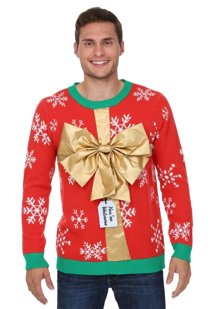 shiny gold large bow, on a red jumper, with white snowflake pattern, and green trims on its cuffs, collar and hem, ugly christmas sweater ideas, on a smiling young man