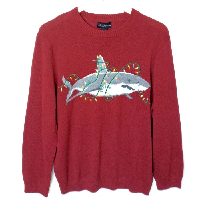 string lights in different colors, wrapped around a grey and white shark, image on a dark red xmas jumper