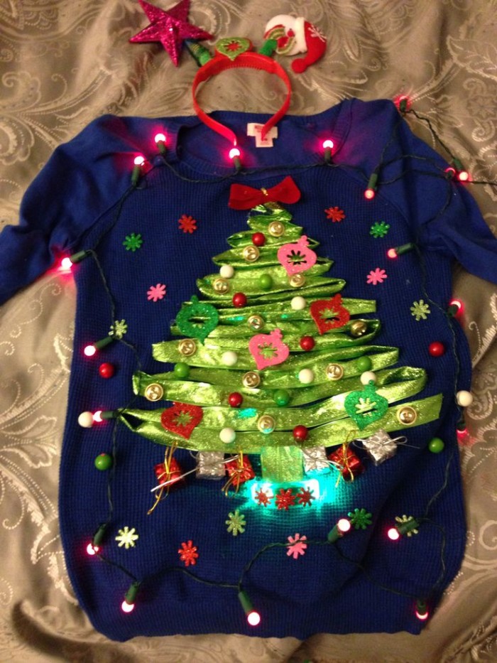 lime green ribbon, shaped like an xmas tree, and stuck on a dark blue jumper, decorated with glowing christmas lights, diy ugly christmas sweater, with multicolored beads and small flowers