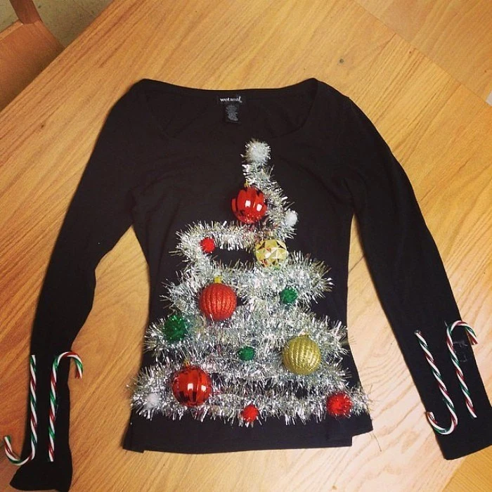 plain black fine knit jumper, decorated with silver garlands, shaped like an xmas tree, with red and green, and gold baubles, diy ugly christmas sweater, two candy canes on each sleeve