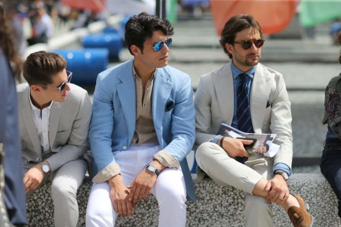 what is semi formal attire, three men with sunglasses, sitting next to each other, wearing white trousers, light colored shirts, and off-white and pale blue blazers