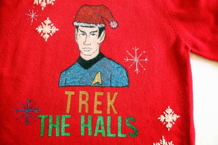 mr. spock hand-drawn on a red, cute ugly christmas sweater, decorated with blue and white snowflakes, and the words trek the halls