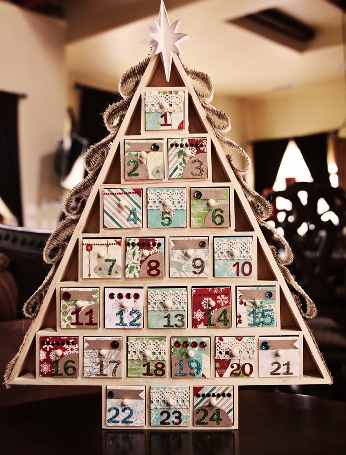 wooden christmas advent calendar, shaped like a triangular christmas tree, with 24 numbered compartments, each decorated with colorful patterned paper