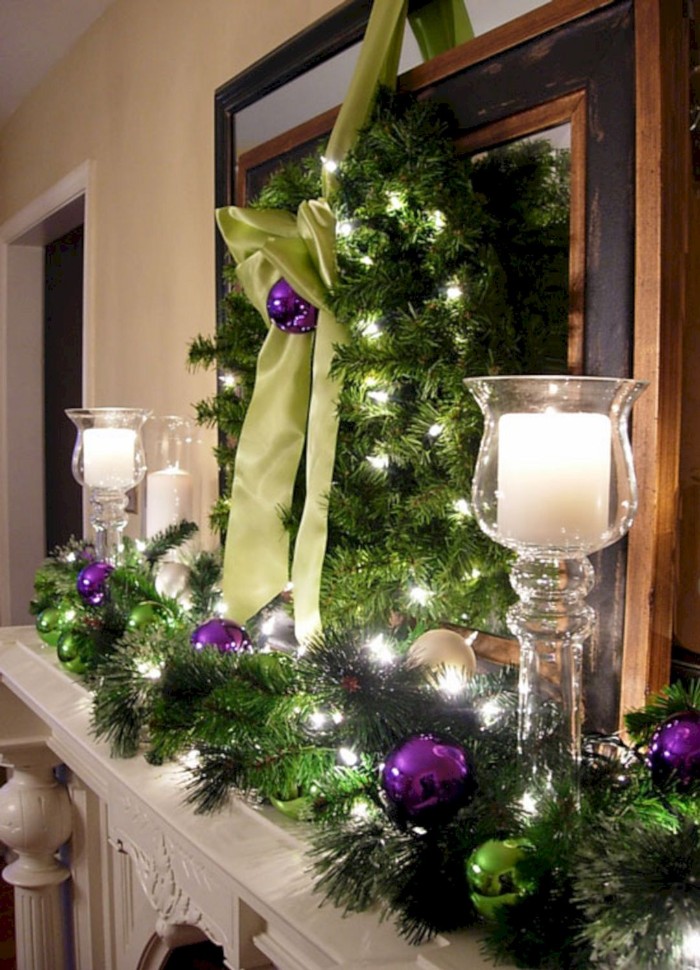 making your own, diy fireplace mantel decoration, with faux fir garlands, candles and christmas baubles, in violet and white