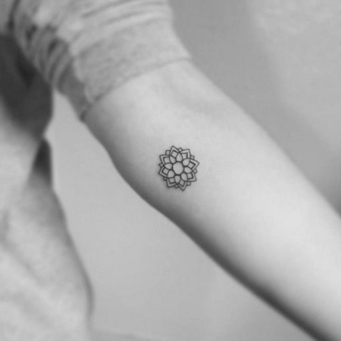 geometrical flower, tattoo on the forearm, tattoos for girls on hand, white background, grey blouse