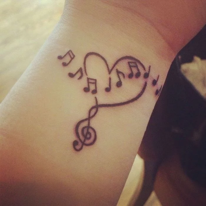 music notes in the shape of a heart, cute tattoos for girls, tattoo on the wrist