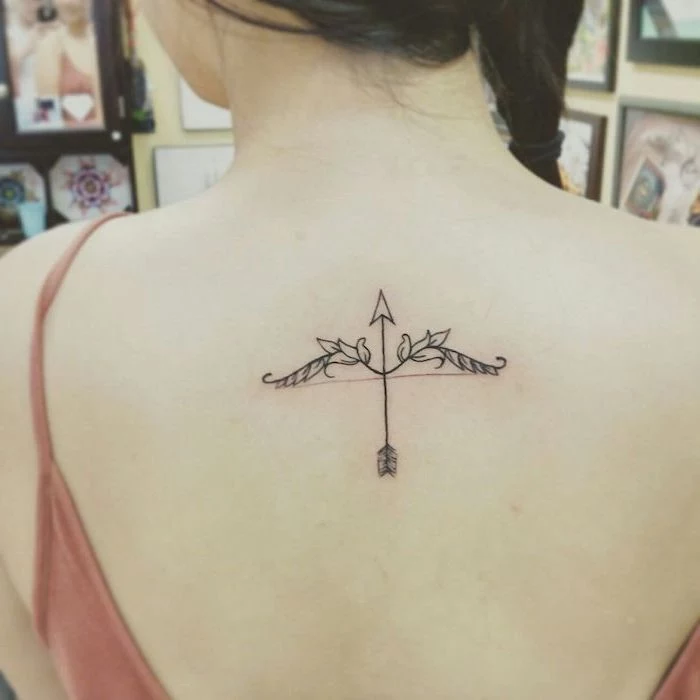 arrow and flowers, tattoo on the back, tattoo ideas for women, orange top