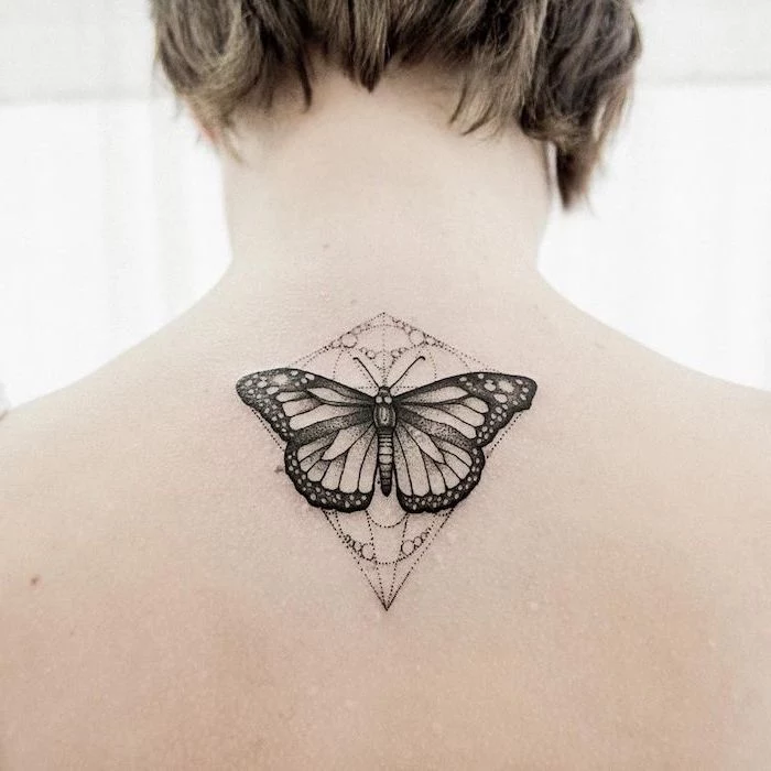 butterfly tattoo on the back, white background, tattoo ideas for women, short dark blonde hair