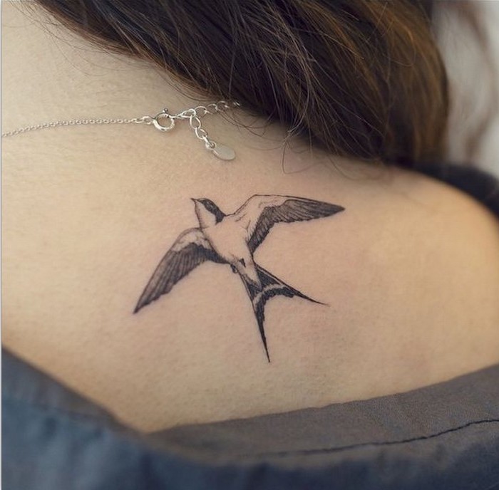 meaningful tattoo ideas, bird tattoo on the shoulder, silver necklace, grey blouse