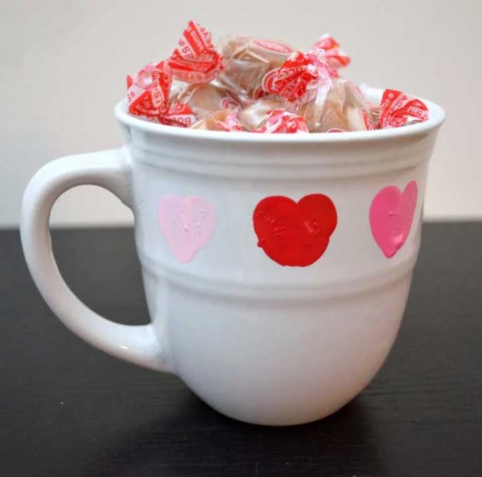 white mug filled with candy, heart shaped thumbprints, creative valentine's day gifts for boyfriend