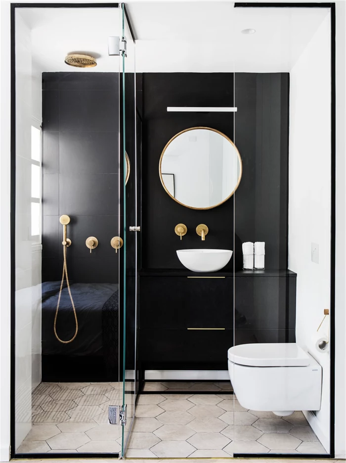 black tiled wall, white honeycomb tiled floor, glass shower door, bathroom shower ideas