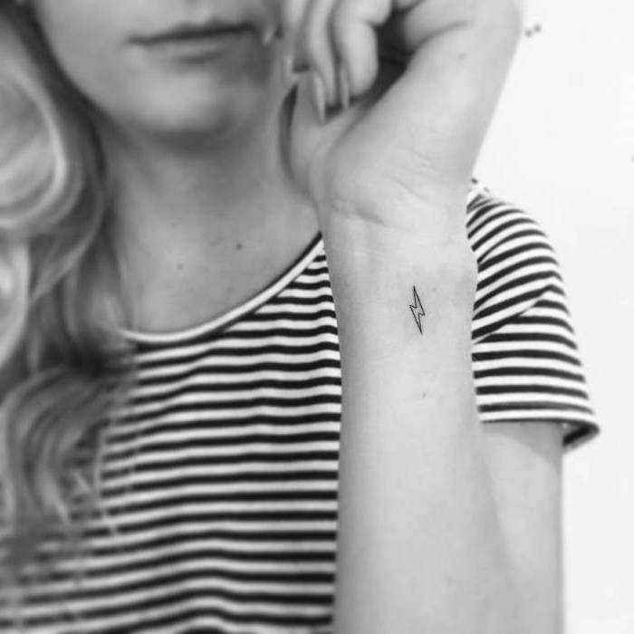 lightning tattoo on the wrist, meaningful tattoo ideas, black and white striped blouse, white background