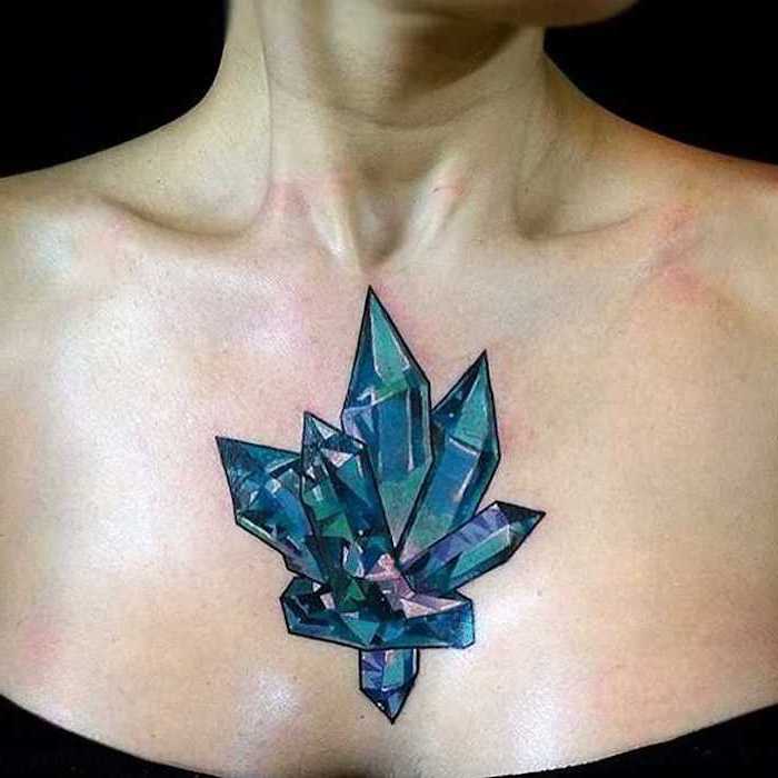 blue crystals, tattoo between breast, black top, black background