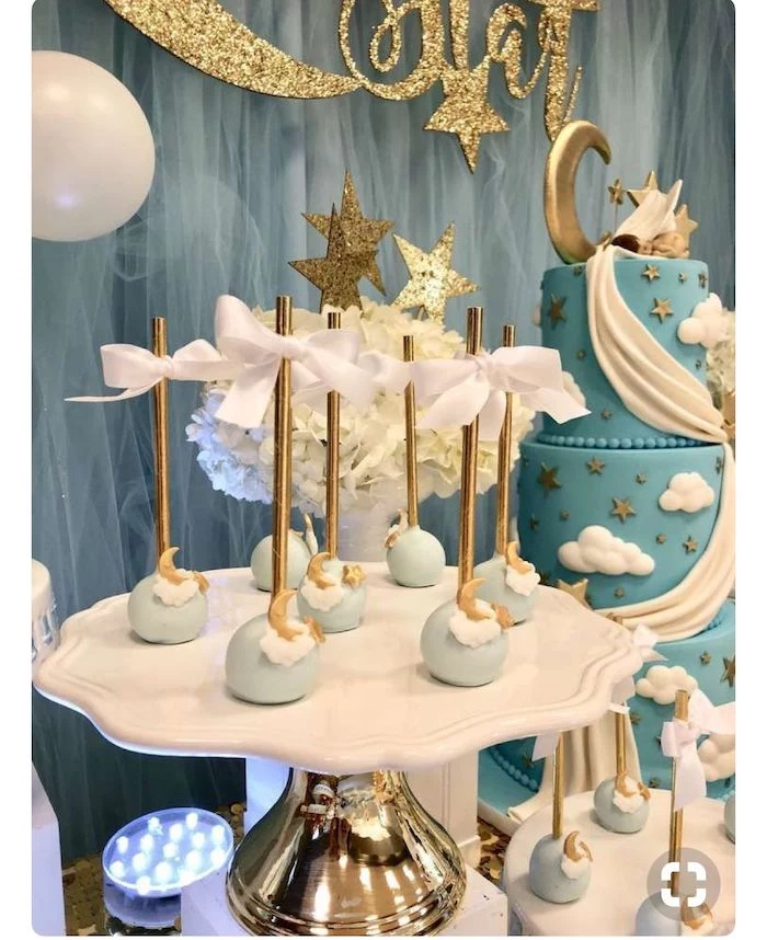 blue and gold moon cake pops, blue tulle, gold and white cake stand, baby shower party ideas