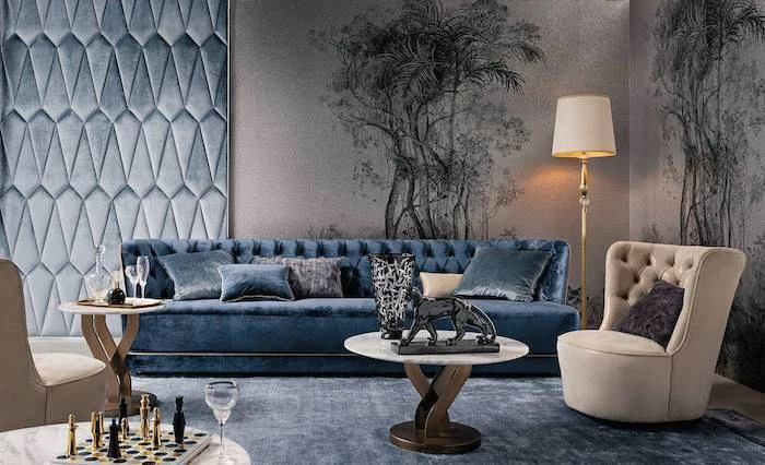 floral prints and blue velvet wall installation, blue velvet sofa and rug, beige armchair, accent wall ideas for living room