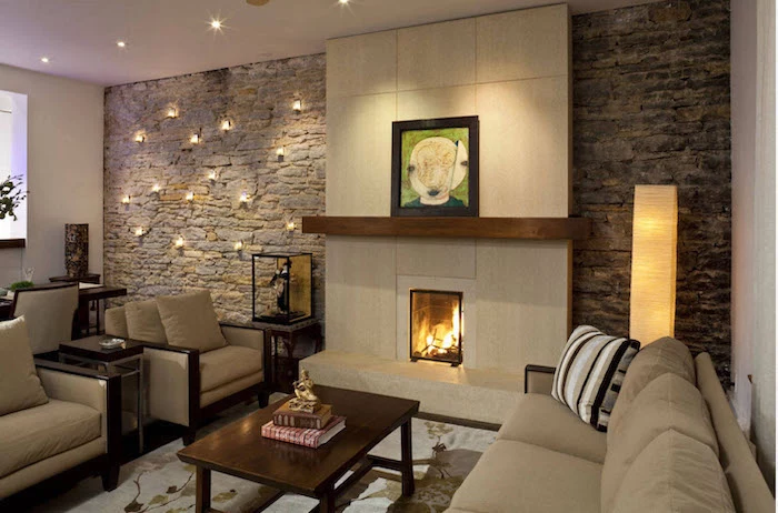 brick wall with lights around the fireplace, beige sofa and armchairs, dining room wall decor