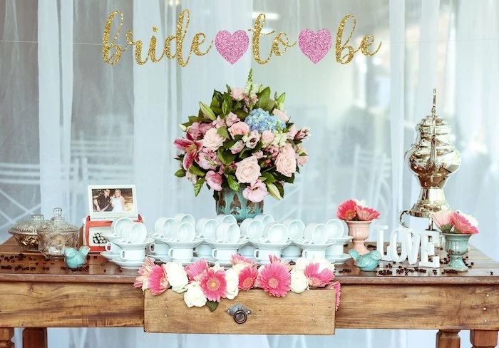 bride to be sign, large flower bouquet, wooden table, fun bachelorette party ideas