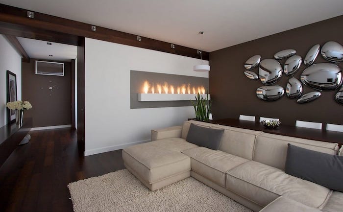dining room wall decor, beige corner sofa, brown wall with metal stones 3d installation
