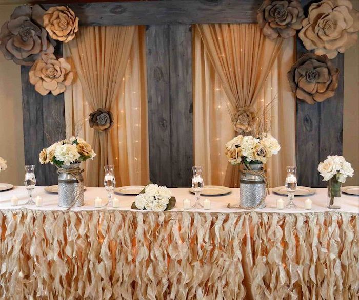 orange tulle with fairy lights backdrop, brown and white flower bouquets in metal vases, brown and beige paper roses, wedding ideas for summer