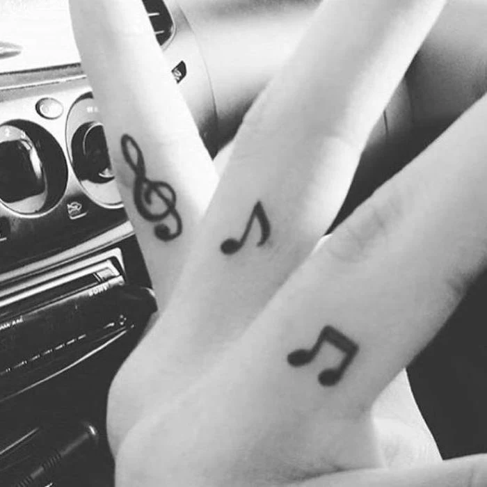 musical notes tattoos on the fingers, cute tattoos for girls