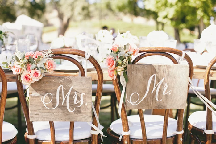 mrs and mr wooden tags on chairs, pink flower bouquets, wedding reception decoration ideas