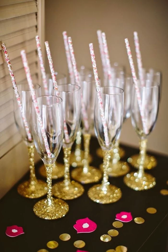 golden glitter, champagne flute, bachelorette games, paper straws, black table