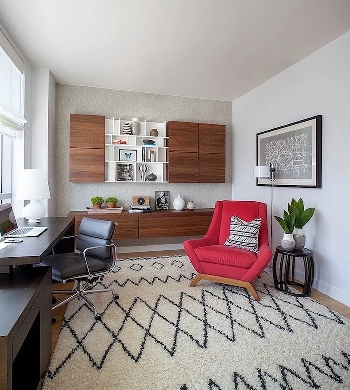 large red armchair, home office design, wooden bookcase with cupboards and shelves, black desk and leather chair