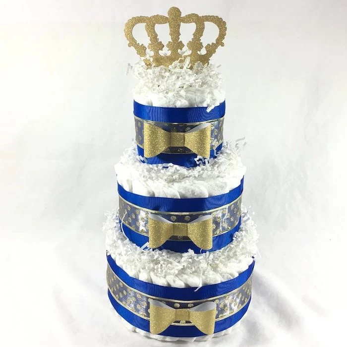 diaper cake, blue and gold ribbon and bows, golden crown on top, baby shower themes