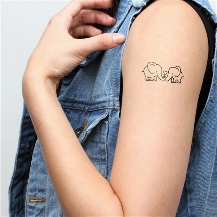 elephants in love, tattoo on the shoulder, denim jacket, tattoo designs for women, white background