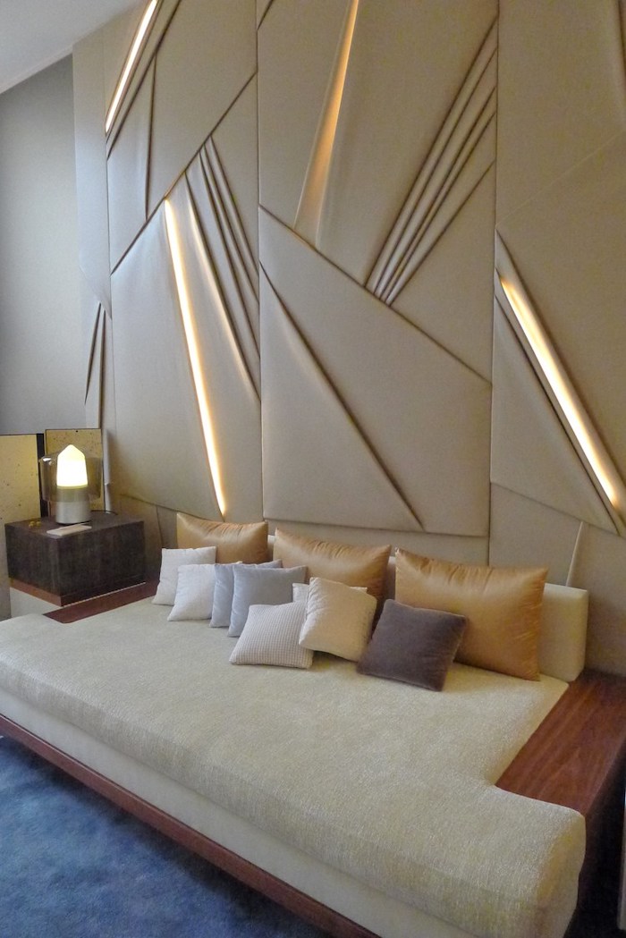 blue velvet rug, fabric and lights wall installation, white sofa, accent wall colors