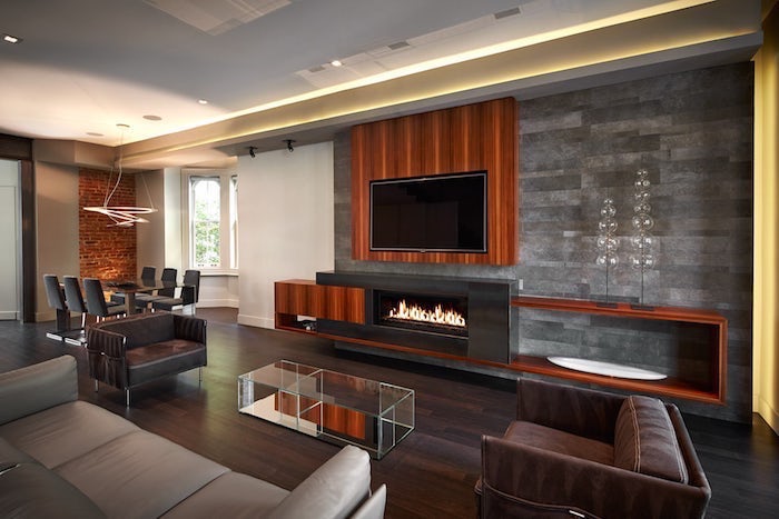 grey tiles and wood on the wall, grey sofa, living room paint ideas, black armchairs