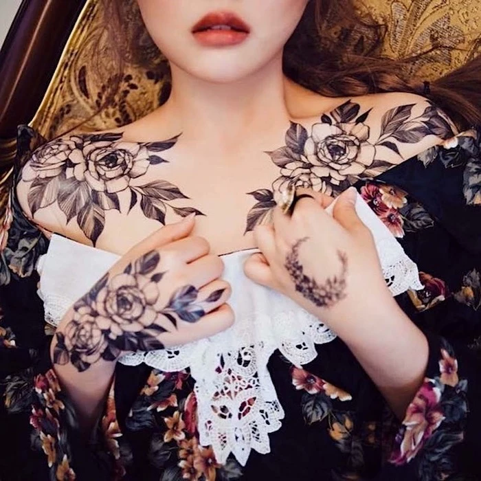floral top, roses and leaves on both shoulders. tattoos on both hands, tattoos for women