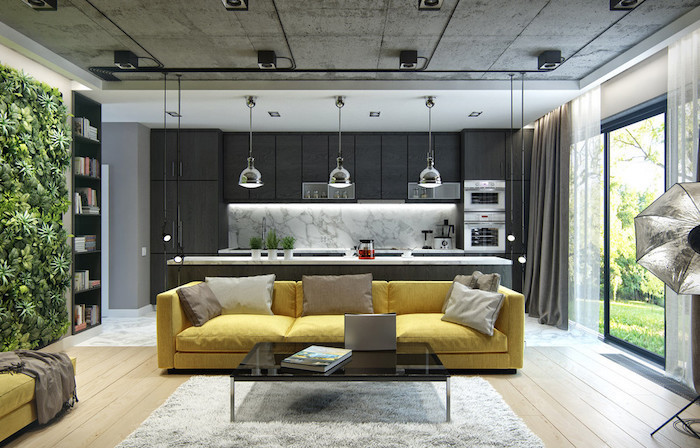 yellow sofa, greenery wall installation, black kitchen cabinets, accent wall colors, white rug