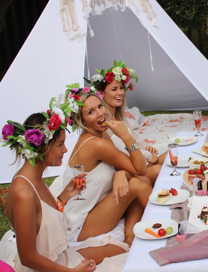 women in white dresses, floral crowns, white tent, bachelorette party game ideas